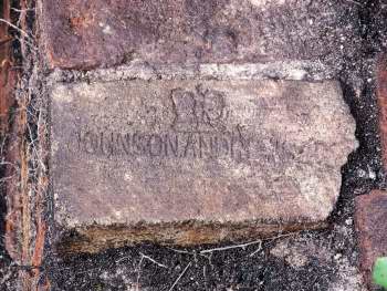 Brick with crown stamped into face