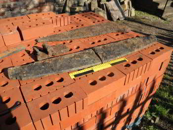 pieces of firebar lying on top of a pallet of red bricks