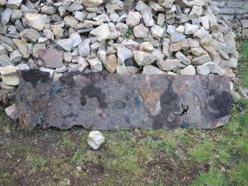 Metal plate lying in front of a stone stockpile